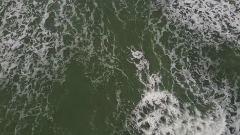 Cornwall-Polly-Joke-drone-shot-looking-down-at-seawaves-in-Cornish-coast,-UK