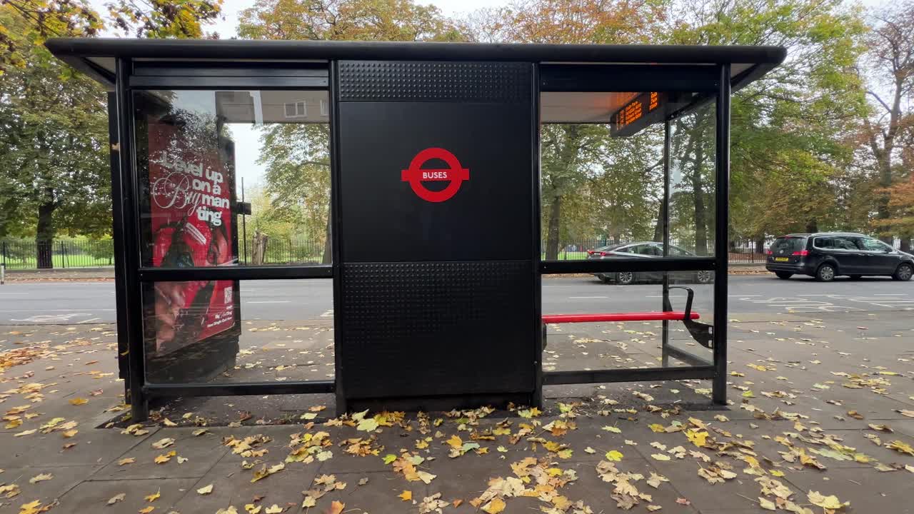 60FPS Handheld shot of a bus stop in London during the fall season