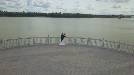 just married people on viewpoint above river aerial view