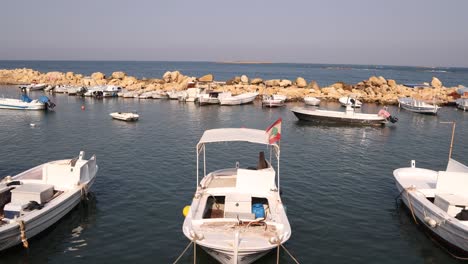 boats with lebanese flag waving in the mediterranean harbor in tripoli, northern lebanon