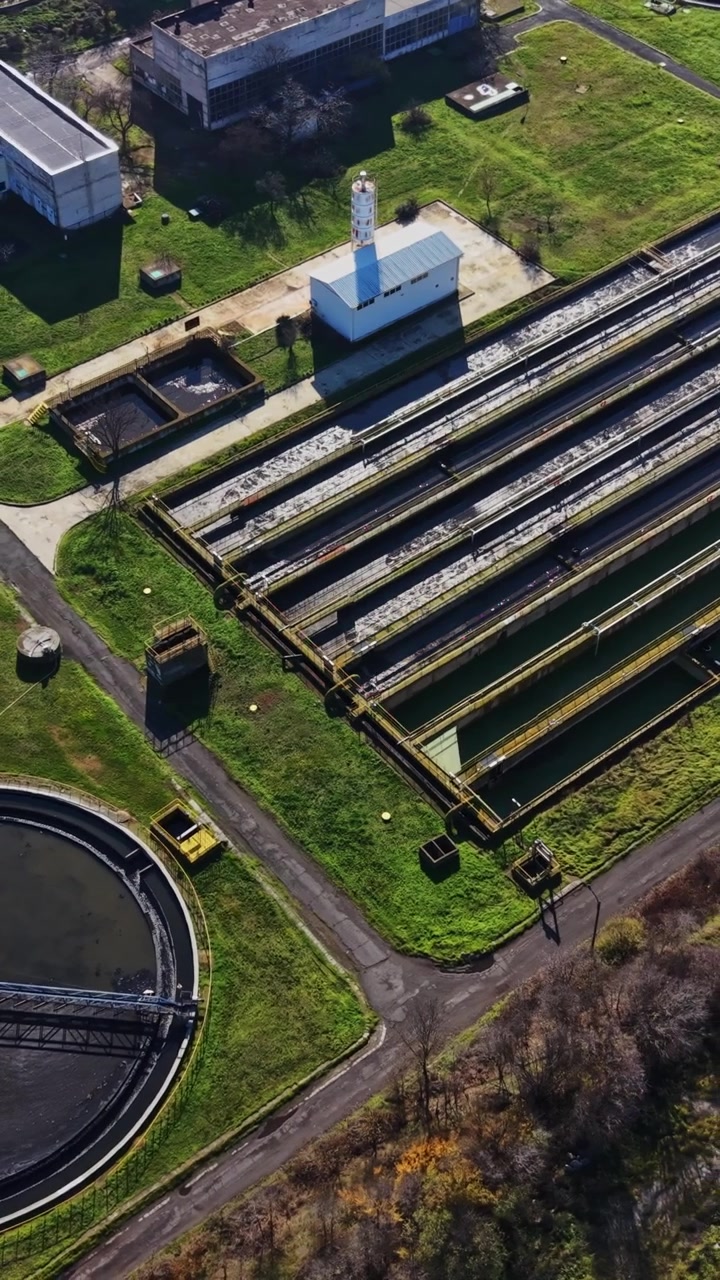 Workers manage a water treatment facility in a clean environment