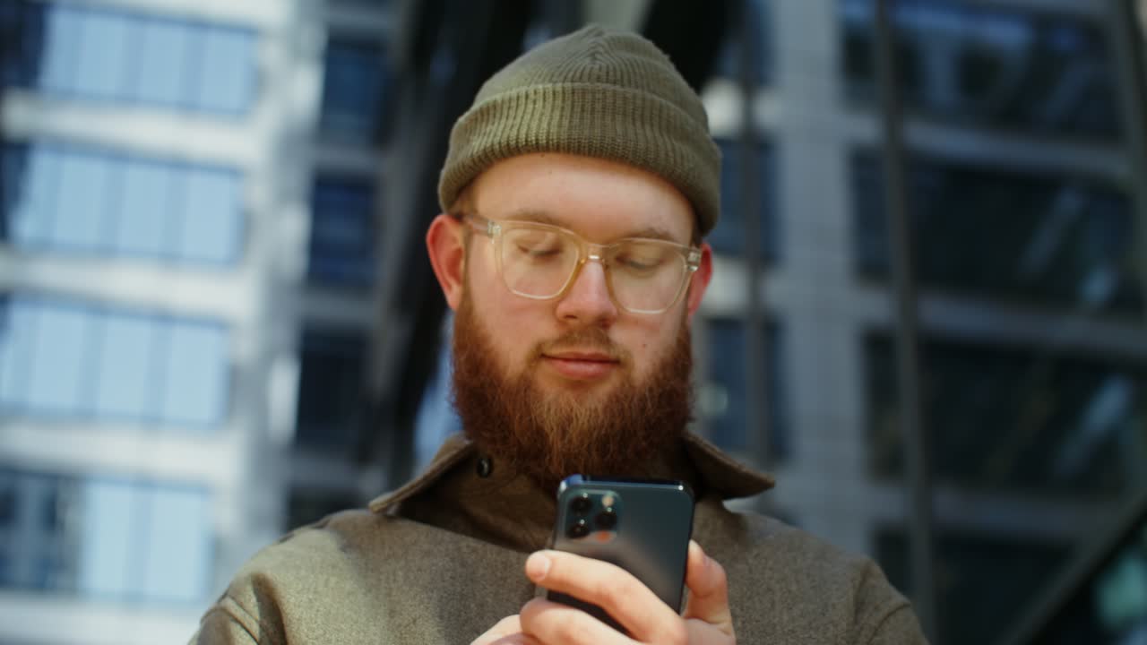 Young Man Using Smartphone in City