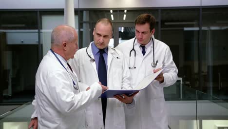 team of doctors discussing over medical report