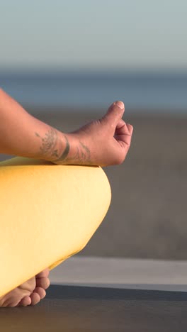 Crop hand of woman in yoga mudra at beach during daytime