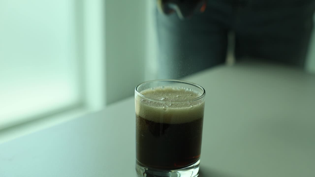 Pouring a soda into a glass