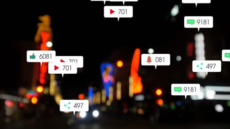animation of social media icons and numbers over out of focus city and traffic lights