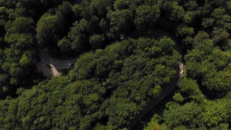 Aerial-look-up-shot-from-a-green-forest-up-to-a-idyllic-placed-monastery-in-southern-bavaria