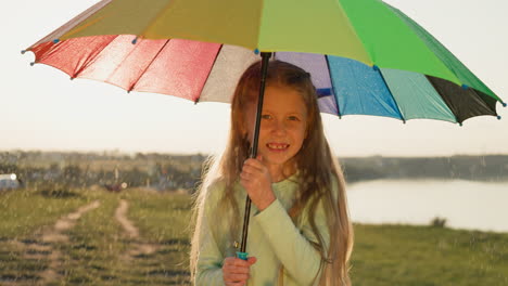 child nestles under parasol on riverbank girl twirls umbrella with glee adding whimsical charm to