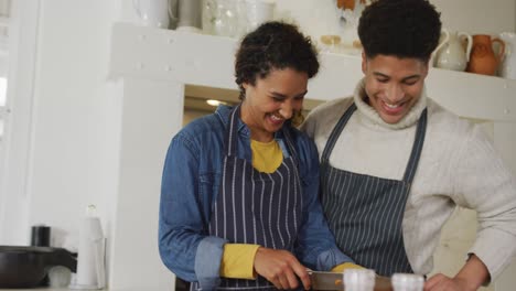 Video-of-happy-biracial-couple-preparing-meal-together