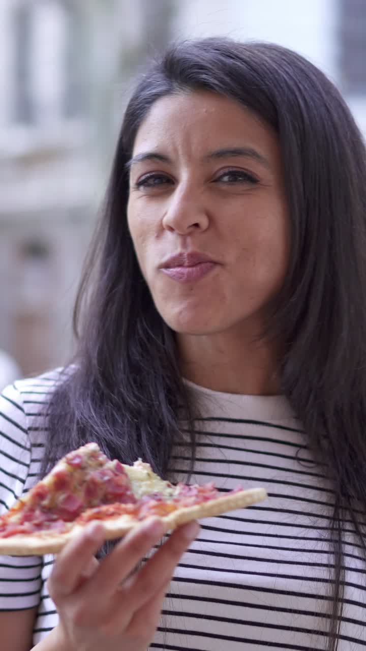Woman enjoying a slice of pizza