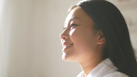 happy young woman in bathrobe