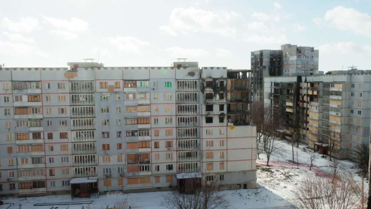 War-Damaged Apartment Building seen from Broken Window in Kharkiv, Ukraine