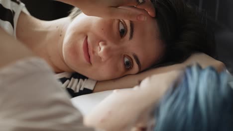 Close-up-video-of-lesbian-couple-tenderly-corrects-her-hair.