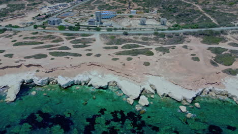 aerial drone trucking shot of a rocky coastline with crystalline water