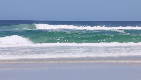 continuous ocean waves breaking on a beach