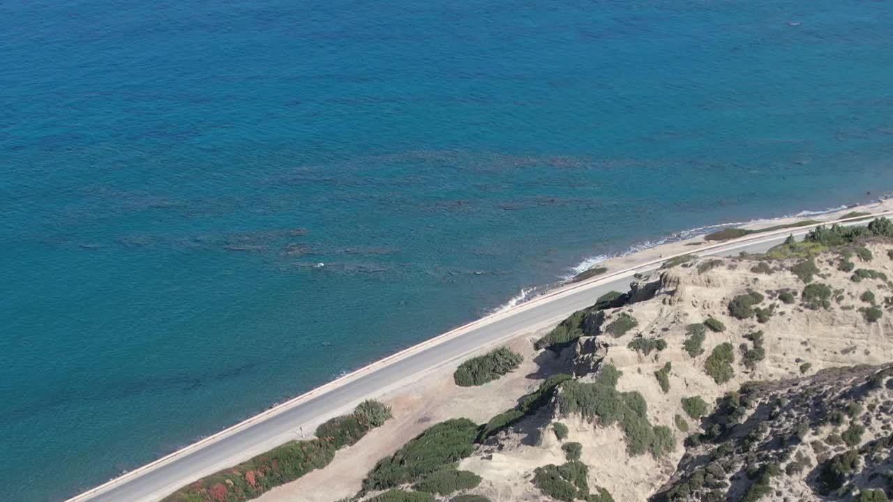 Aerial view of the rocky coastline in Greece showcasing clear blue waters