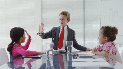 Kids-as-business-executives-having-a-meeting-in-the-board-room-4K-4k