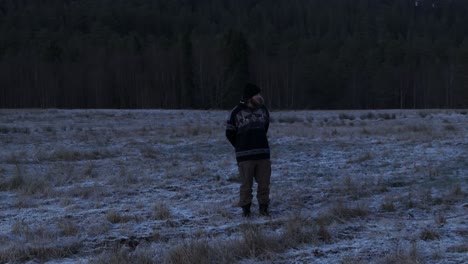 Indre-Fosen,-Trondelag-County,-Norway--On-the-Farm-in-November,-a-Man-Walks-His-Dog---Tracking-Shot