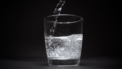 Mineral-water-in-a-transparent-glass-in-slow-motion