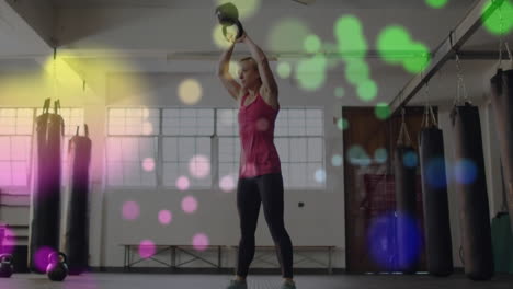 lifting kettlebell, woman exercising over colorful bokeh lights animation