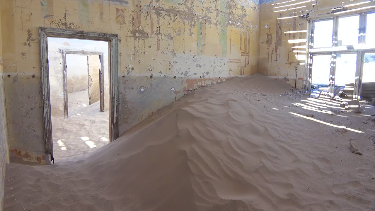 Sand fills an abandoned building in the gem mining ghost town of Kolmanskop Namibia
