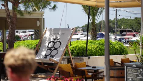 deck chair advertising drinking cocktails and coffee at a local bar