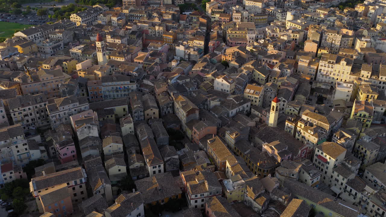 Corfu Old Town and rooftops at sunrise with soft glow over peaceful historic city, aerial patterned urban texture backdrop