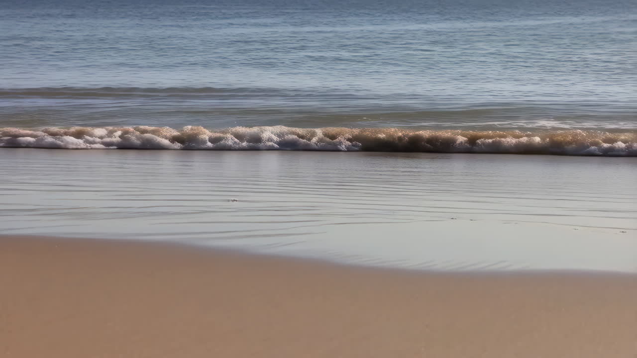 Gentle ocean waves on a sandy beach