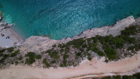 Turquoise-sea-water-reflecting-sunlight-near-rocky-shore-in-Mediterranean-coastal-line-of-Albania