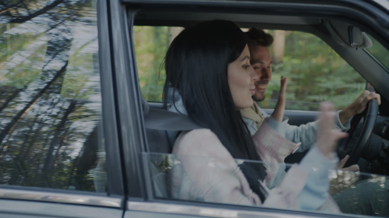 Couple enjoying a drive through the forest