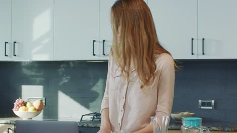 business woman preparing breakfast. relaxed female person checking mobile phone