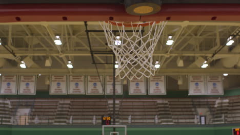 A-woman-basketball-player-shoots-the-ball-for-a-basket-during-a-layup-at-practice