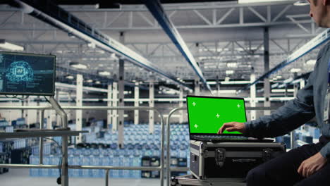 data center employees check ai dashboard using green screen laptop