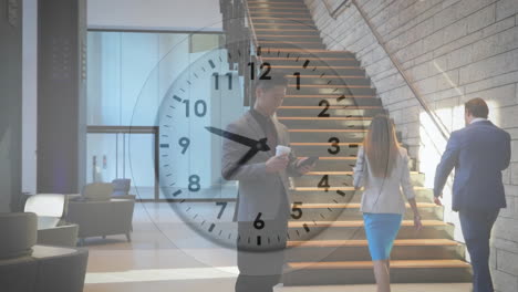 animation of clock with fast moving hands over caucasian businessman in foyer using smartphone