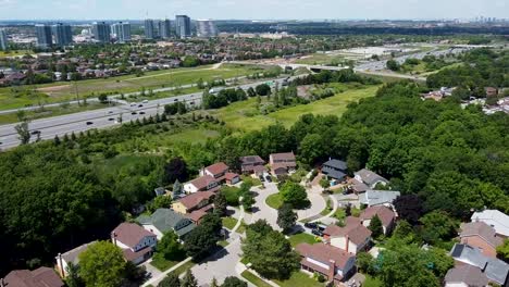 view of a highway next to a mississauga neighborhood from a drone