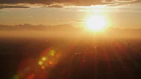 silhouette of milan buildings during golden orange sunset, aerial view