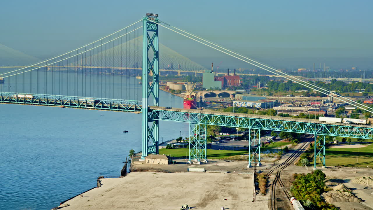 Drone gliding over Detroit River, capturing the freighter and skyline from above