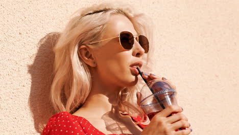 stylish woman enjoying a drink outdoors