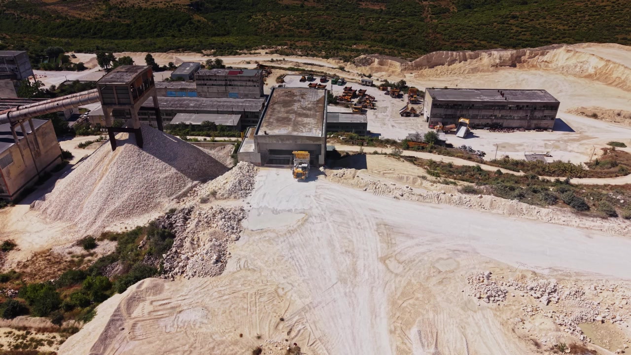 Abandoned industrial site with machinery and rocky terrain