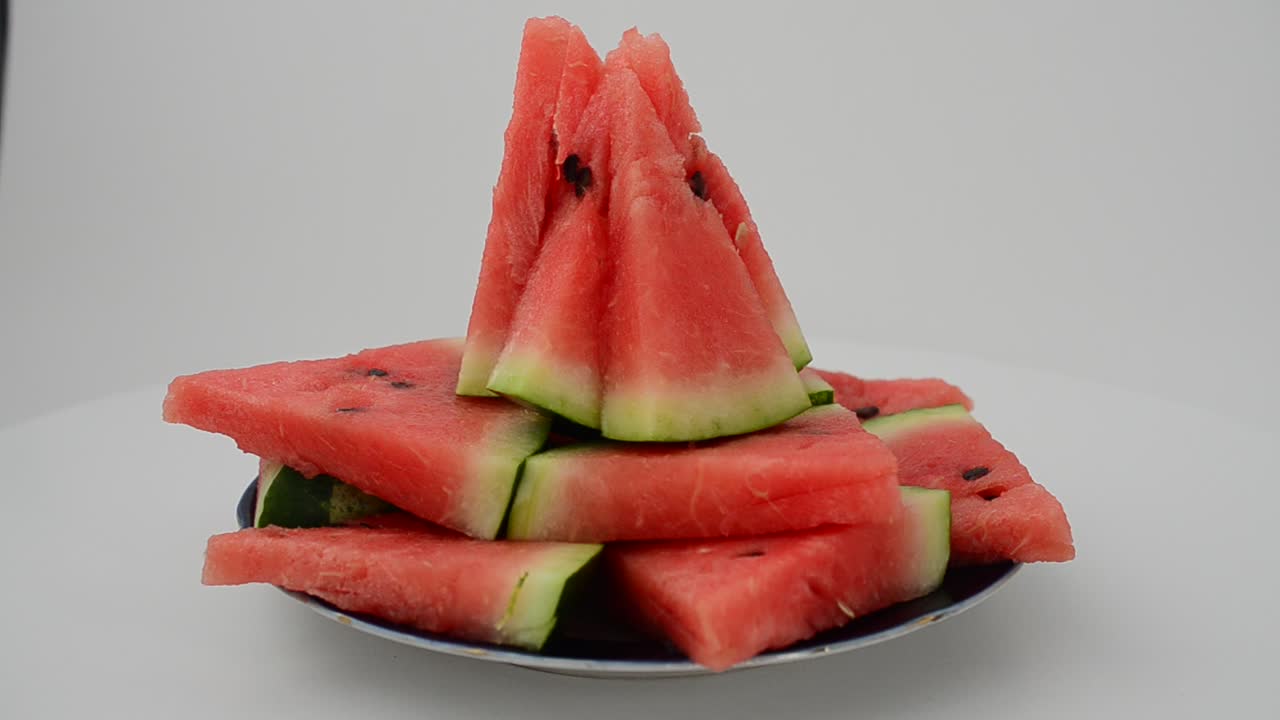 Shooting of a watermelon on a white background. Shooting in the movement