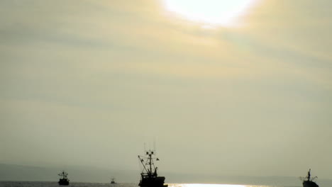 Boats-move-through-the-water-as-the-sun-starts-to-set