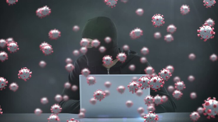 Animation of of macro covid19 cells over man wearing balaclava, using a laptop