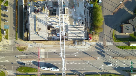 aerial top down view of construction tower crane over urban building development area