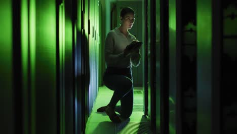 Caucasian-female-it-technician-using-tablet-checking-computer-server