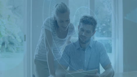 using tablet with digital animation, man and woman in bright room