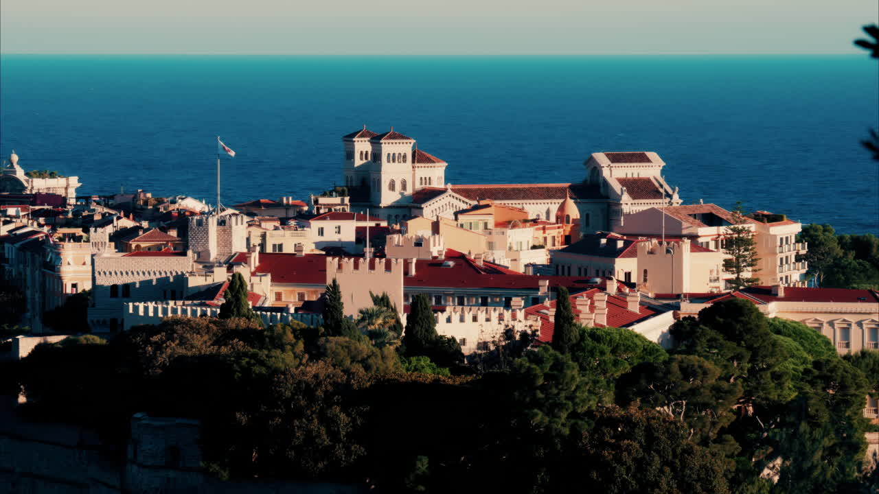 Distant aerial view of the Prince's Palace in the skyline of Monaco with the sea on the background