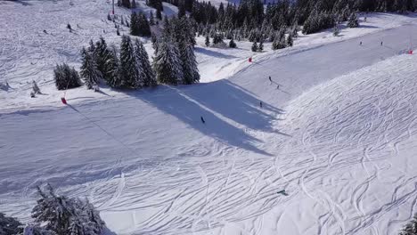 pass looking down over a piste with people