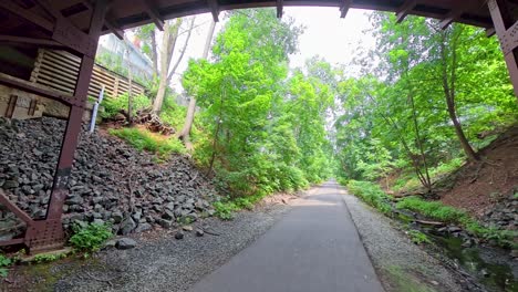walking beneath an underpass along the middlesex greenway in metuchen, nj