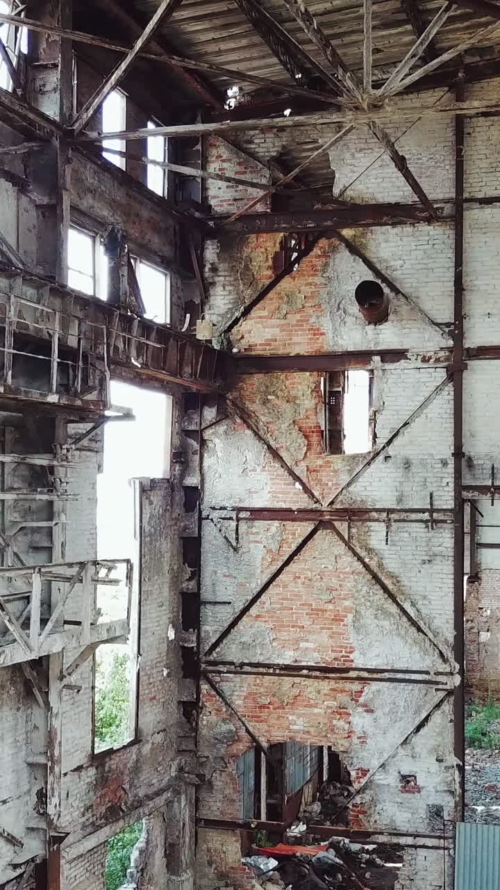 Aerial view of the ruined buildings from the war. Factory ruins. Vertical video