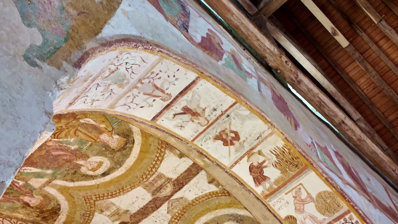 Ceiling detail of historic chapel showing intricate religious artwork and designs